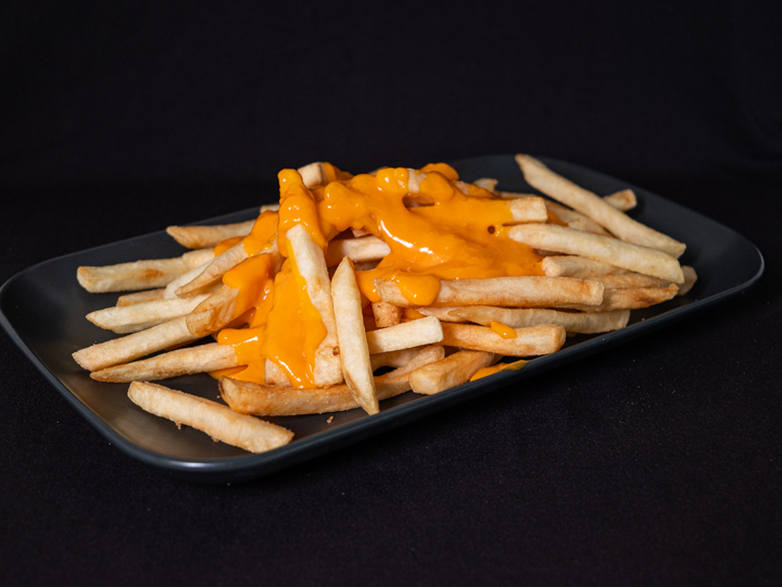 porción de papas fritas con chedar